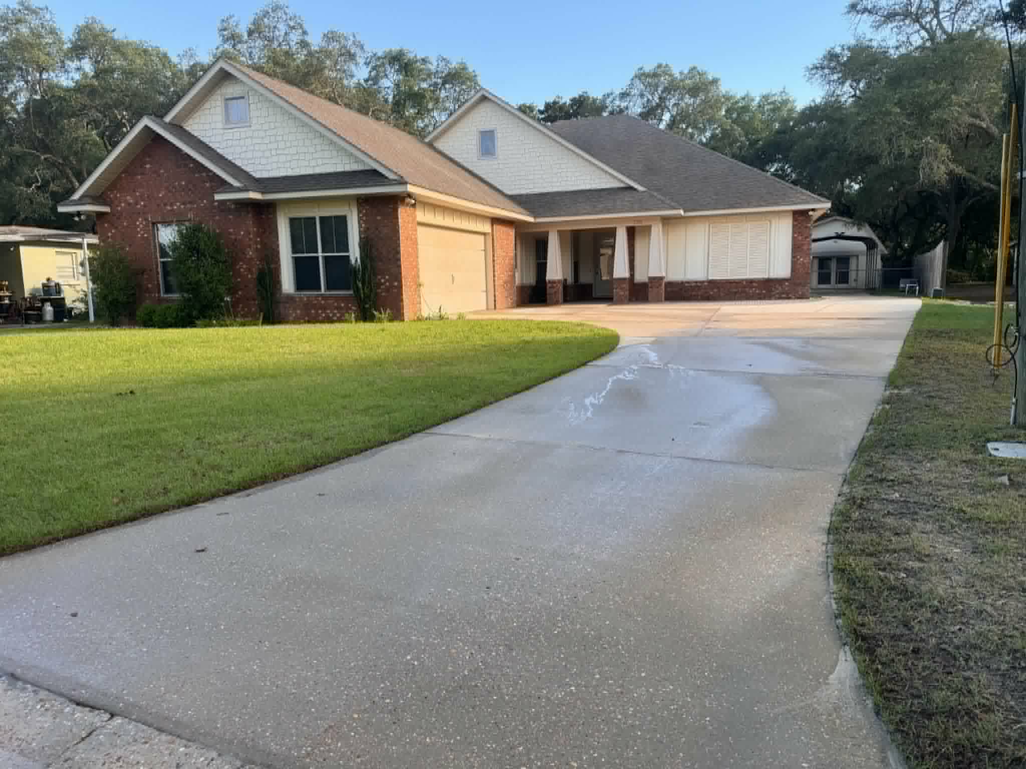 Algae covered brick and tire mark driveway in Fort Walton,FL.